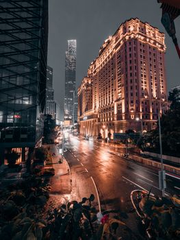 A stunning nighttime view of city architecture with illuminated buildings and empty streets.