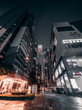Dramatic night cityscape showcasing modern skyscrapers and urban architecture.