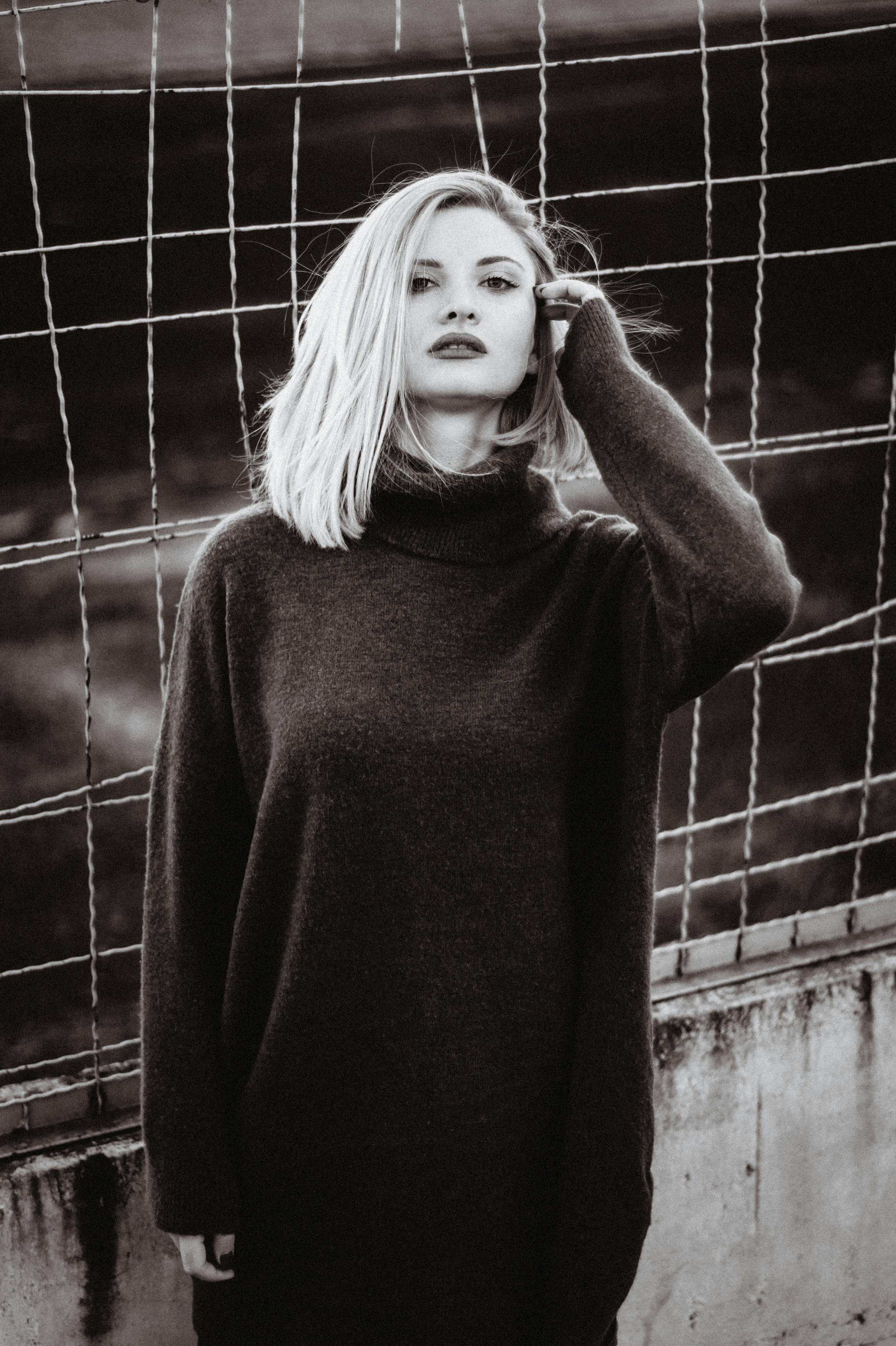 Monochrome portrait of a woman with moody shadows and high contrast.