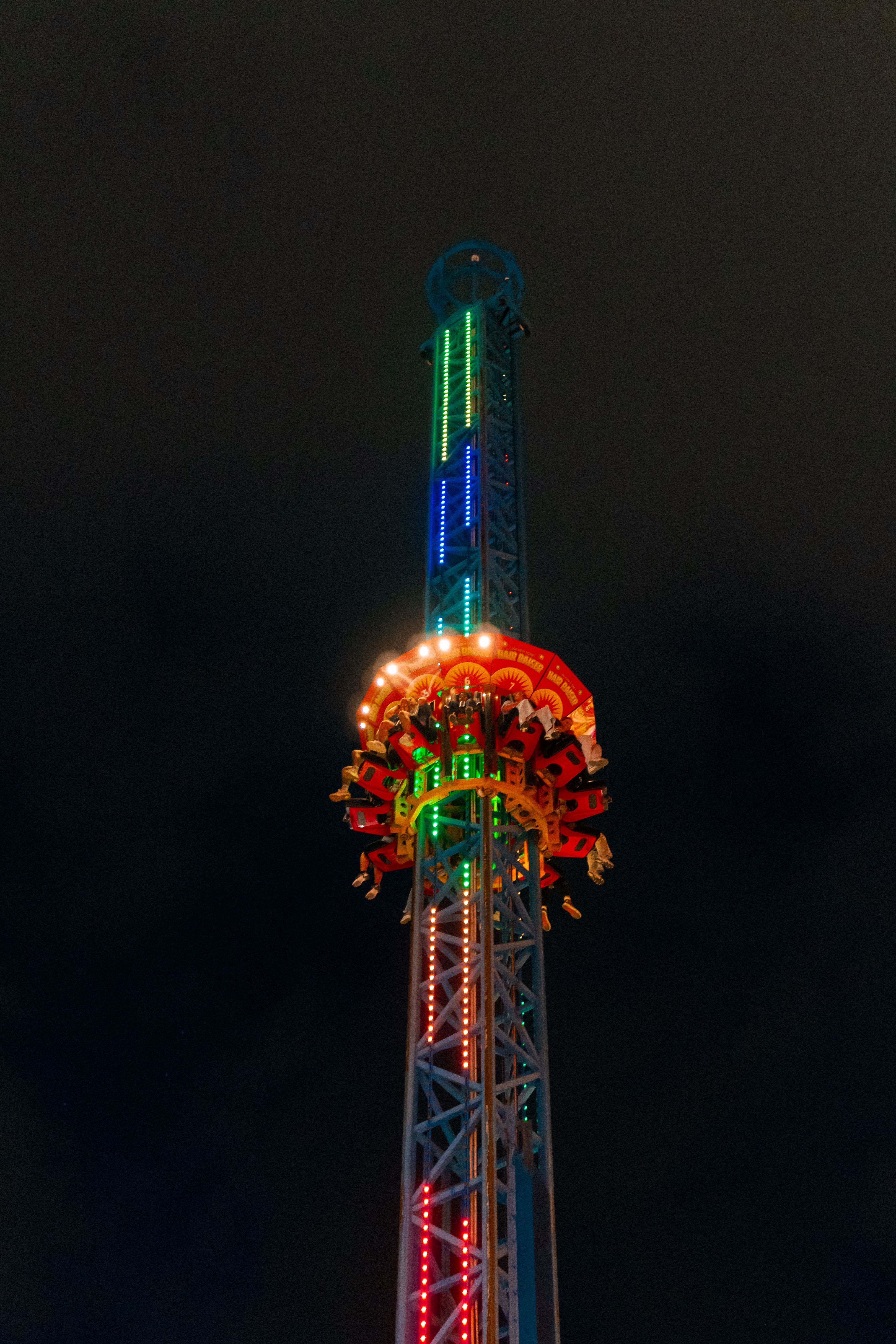 Illuminated Nighttime Amusement Park Ride Tower · Free Stock Photo