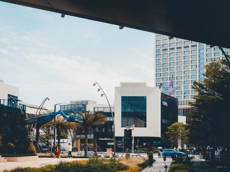 Contemporary cityscape featuring modern buildings and urban infrastructure under clear sky.