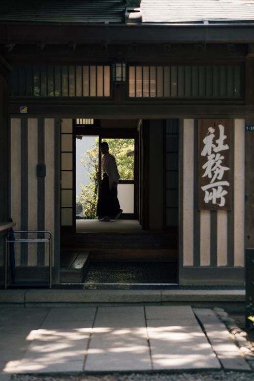 Free Man in traditional outfit inside a historic Kamakura building. Stock Photo