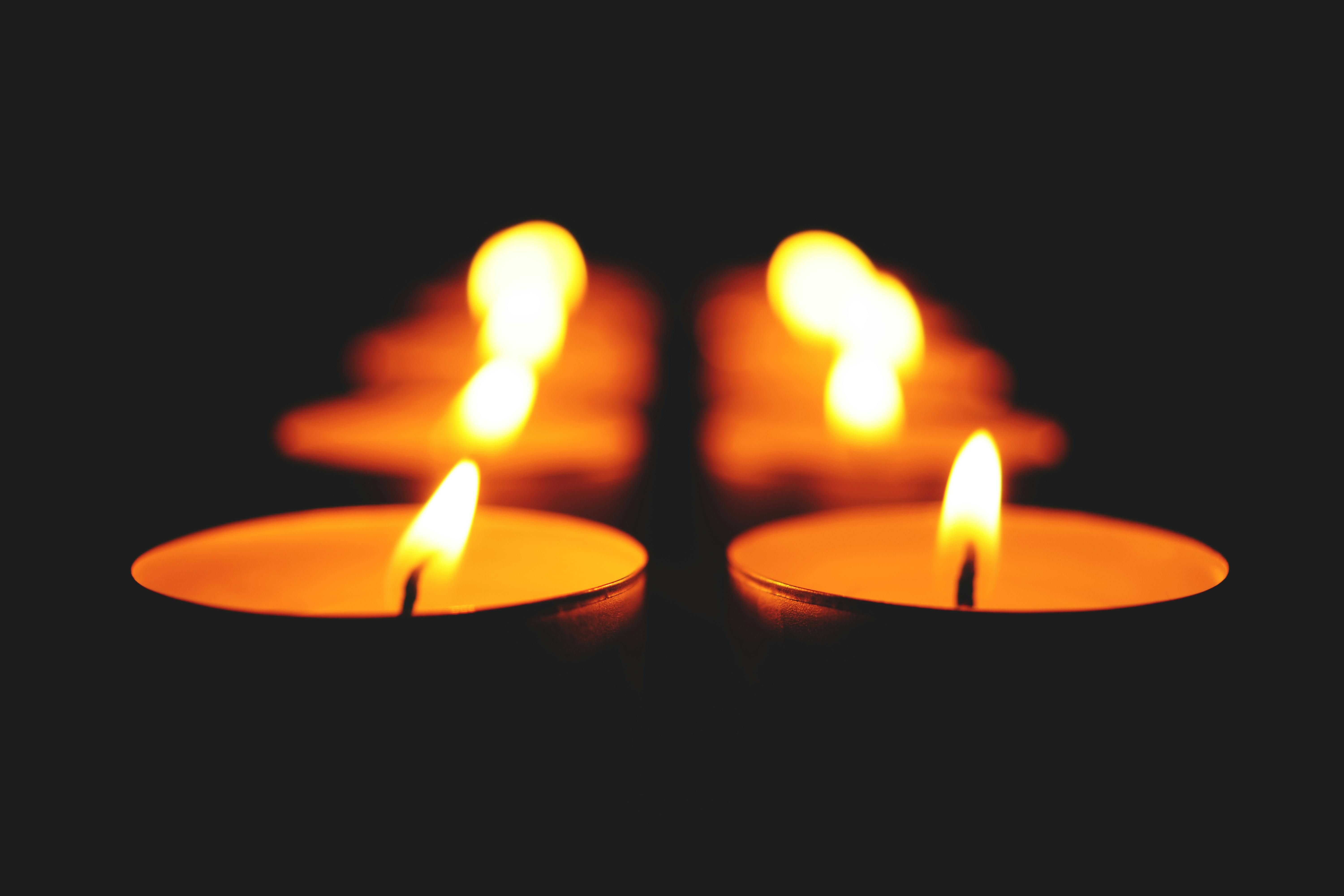 close up of illuminated candle against black background