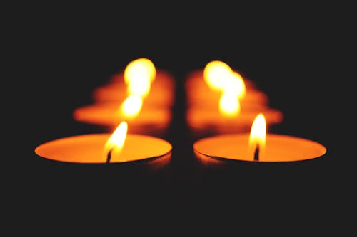 Close-up of Illuminated Candle Against Black Background