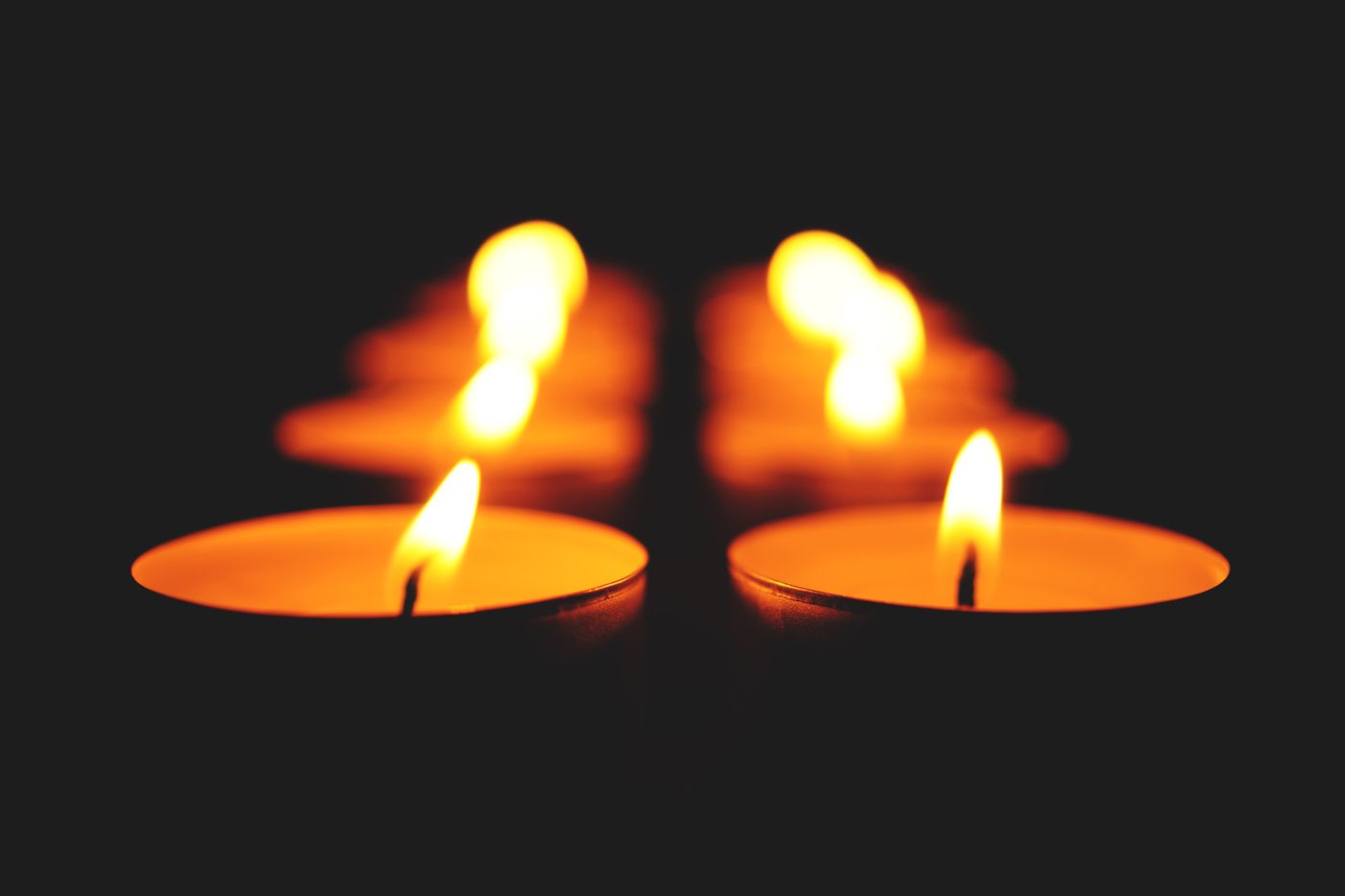 A single candle against a dark background