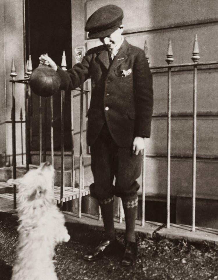 Grayscale Photography Of Boy Playing Ball With The Dog