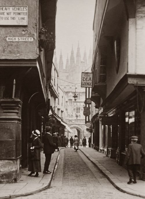Free Historical black and white photo capturing a busy, narrow street with people and vintage buildings. Stock Photo
