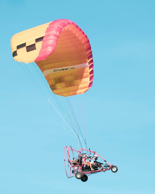 Free Exciting paramotor gliding through the sky offering a thrilling adventure experience. Stock Photo