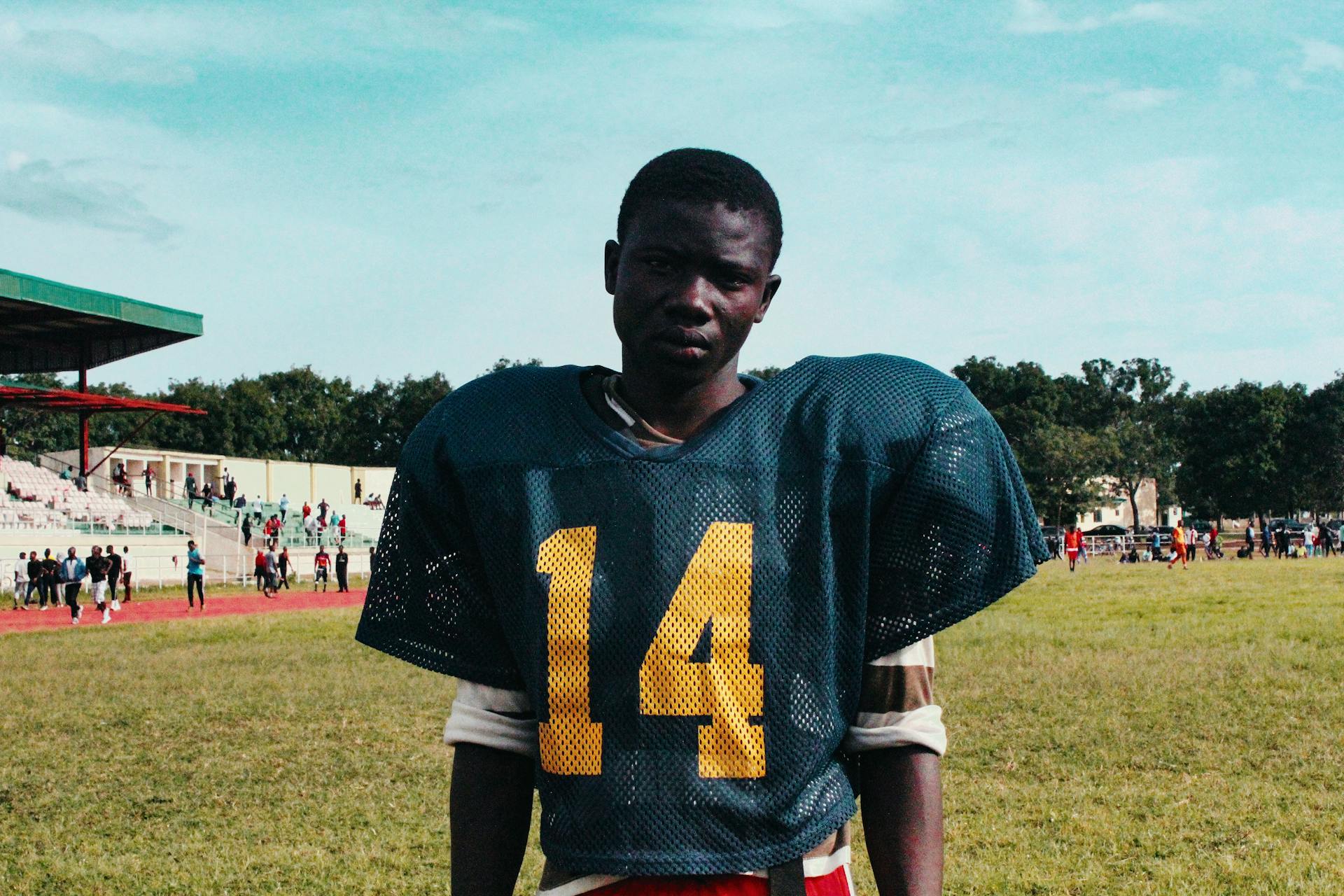 Black player of American football on stadium