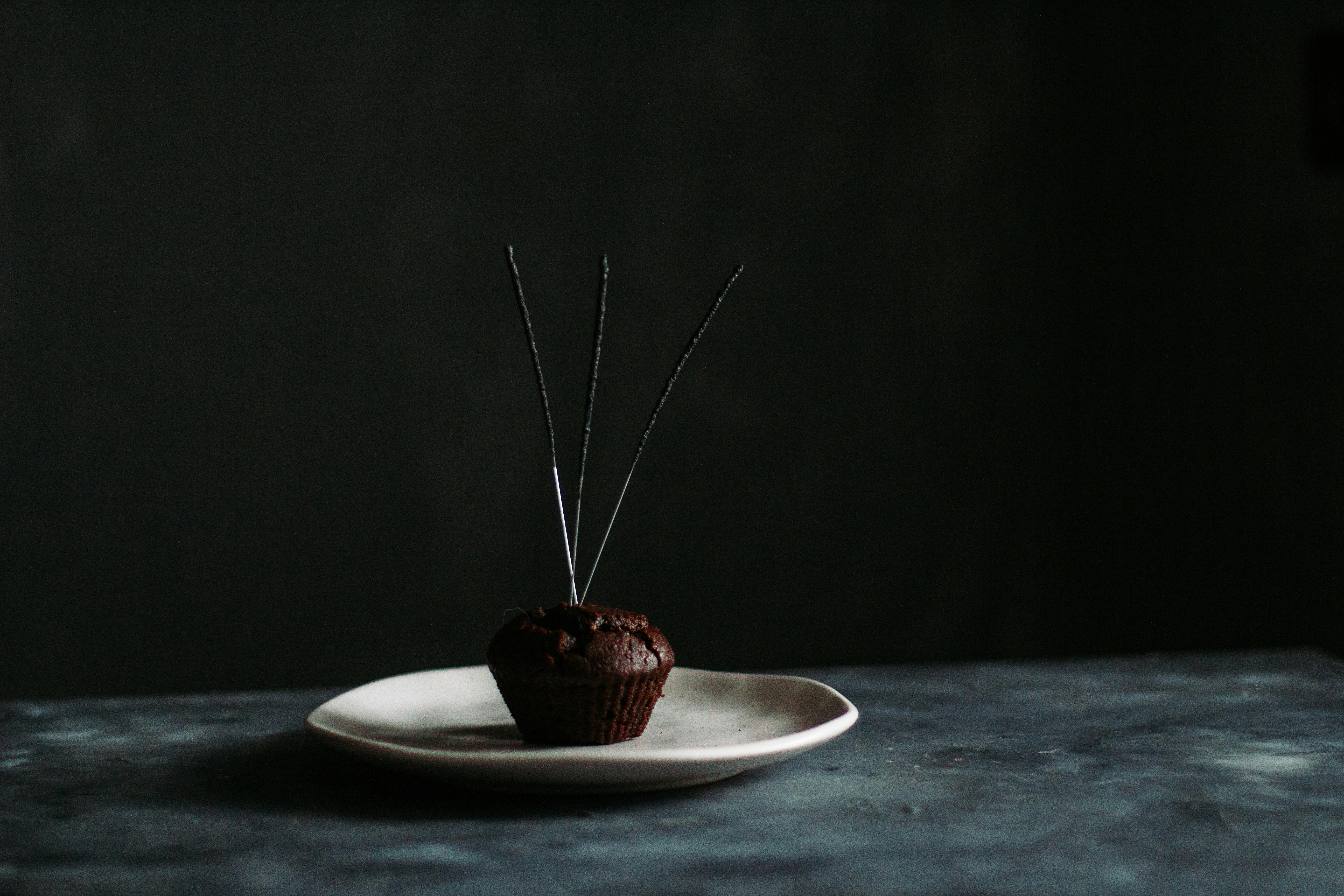 chocolate muffin with firework sparklers on plate