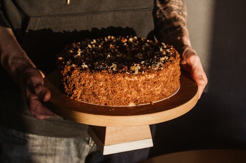 Person Holding, A Delicious Looking Round Cake