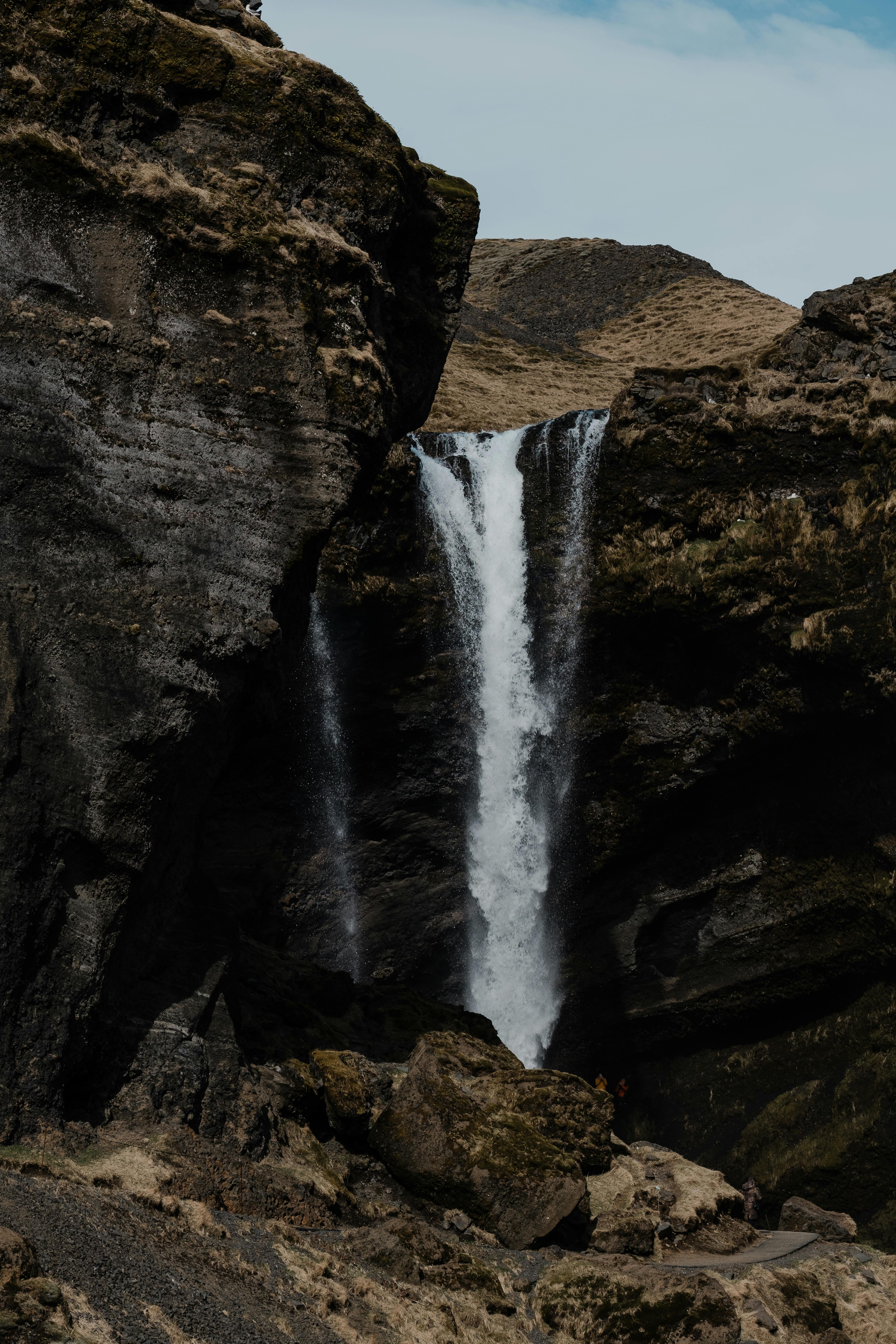 Stunning waterfall cascading down a rocky canyon, showcasing natural beauty and grandeur.