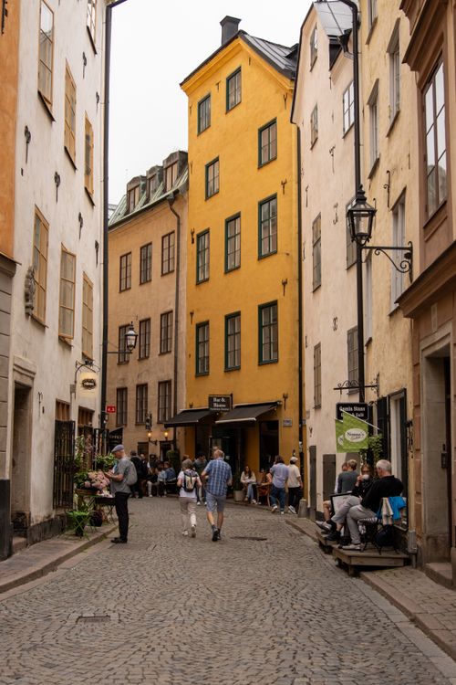 Free Cobblestone street view in historic Gamla Stan, Stockholm, with colorful buildings and local life. Stock Photo