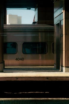 Warm morning view of a train at a sunny New York City platform capturing vintage vibes.