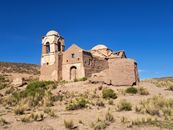 Ancient ruined building in La Paz, Bolivia, set against a clear blue sky.