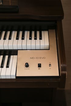 Detailed view of an electric piano's keyboard and control panel with vintage style.