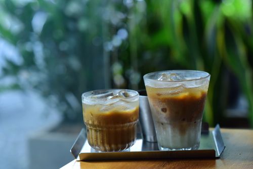 Free Refreshing iced coffee drinks served on a tray in a relaxed cafe setting. Stock Photo