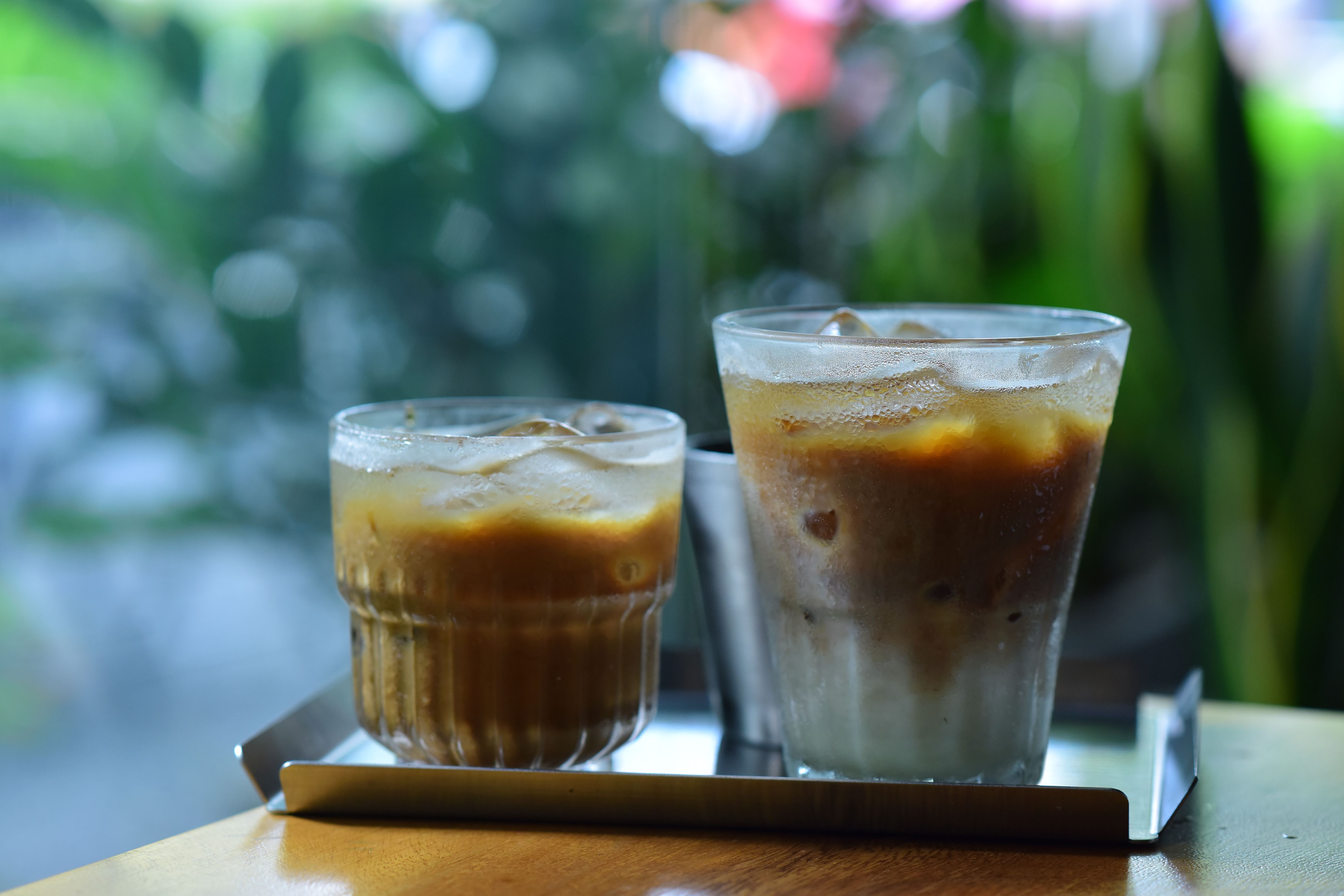 Two iced coffee drinks on a table, perfect for a refreshing break.