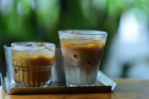 Free Two iced lattes served on a wooden table, perfect for a refreshing break. Stock Photo