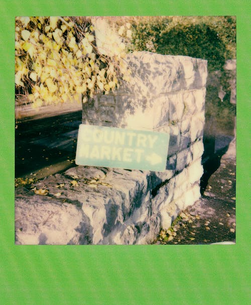 Concrete Wall With Country Market Signboard