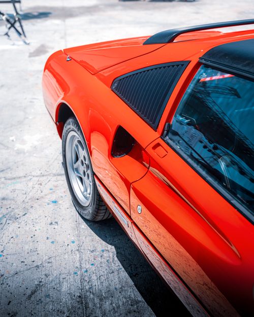 Free Close-up of a classic red sports car basking in the summer sun, Alaçatı, Türkiye. Stock Photo