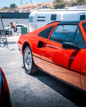 Stunning red sports car parked outdoors under bright sunlight in Alaçatı, İzmir, Türkiye.