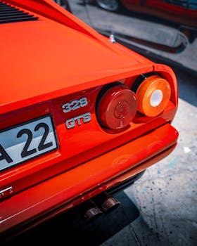 Close-up of a vibrant red Ferrari 328 GTS parked in Alaçatı, Türkiye, showcasing its iconic design.