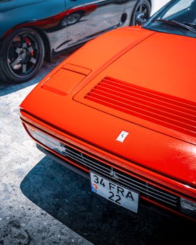 Vibrant red sports car basking in Alaçatı's sunlight, showcasing its sleek design and Italian flair.