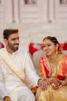 Vibrant Indian couple sharing a joyful moment during their wedding ceremony in Hyderabad, India.