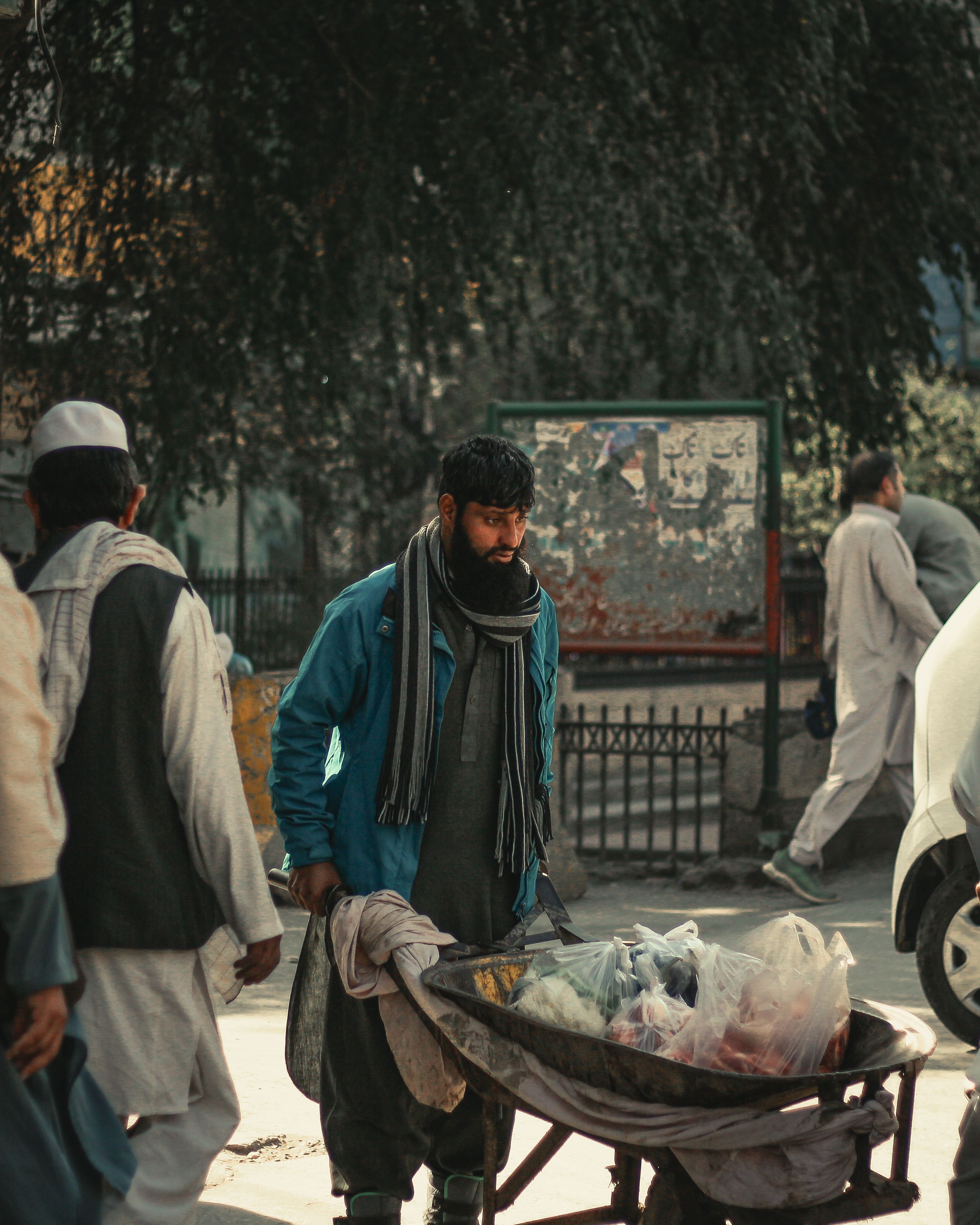 Street vendor pushing cart in Peshawar's busy market street showcasing local culture and lifestyle. - Comparison of Different Forms of Shilajit