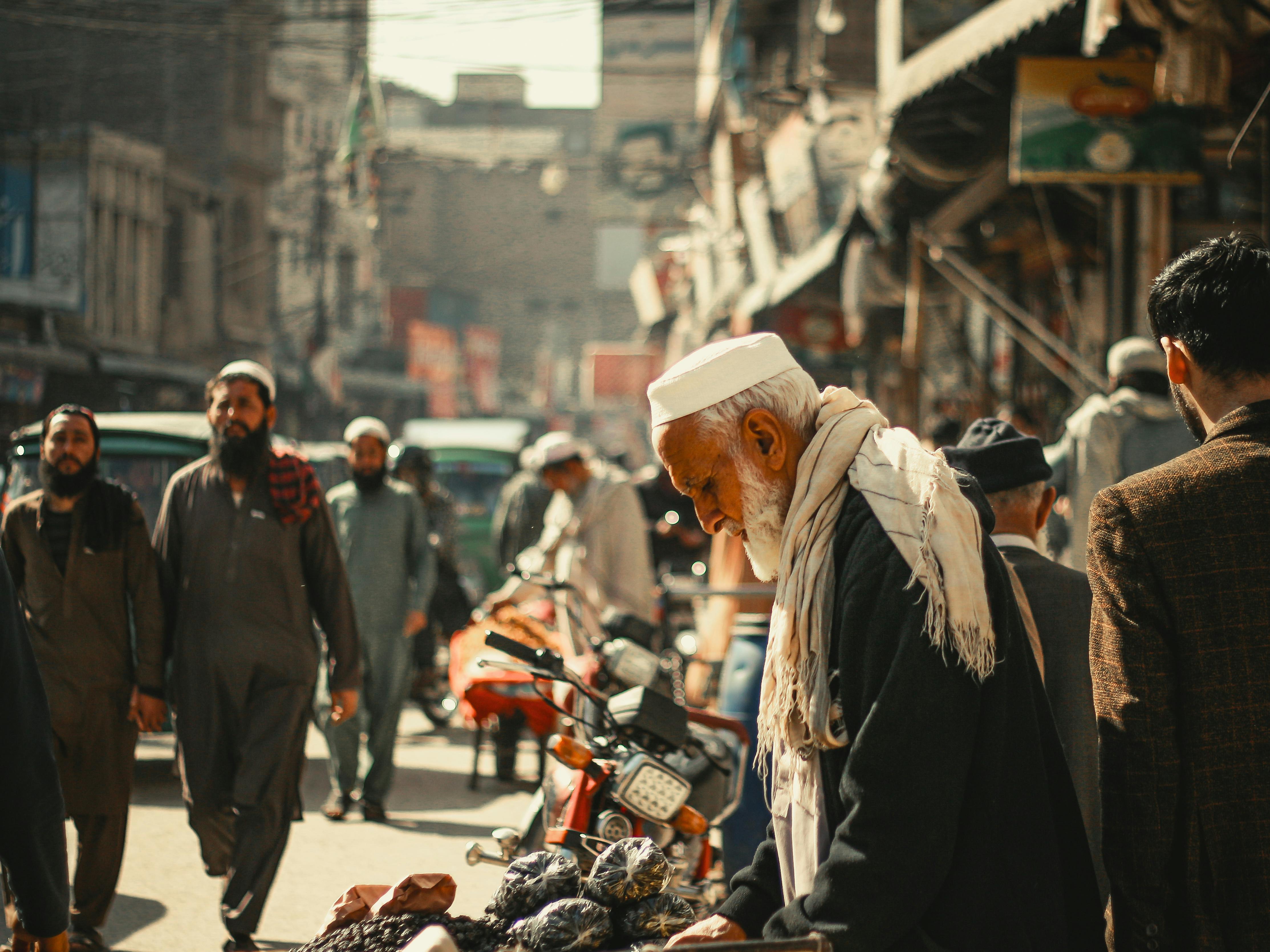 A vibrant street in Peshawar, Pakistan, featuring local culture, market hustle, and diverse individuals.