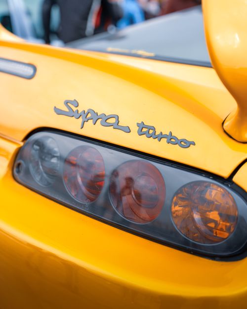 Free Detailed shot of a yellow sports car's tail light with 'Supra Turbo' branding in Ankara, Türkiye. Stock Photo