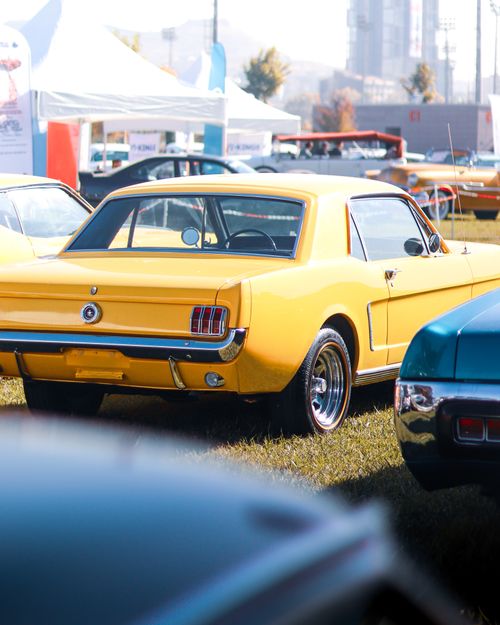 Free Classic yellow car displayed at an outdoor auto exhibition in Ankara, Türkiye. Stock Photo