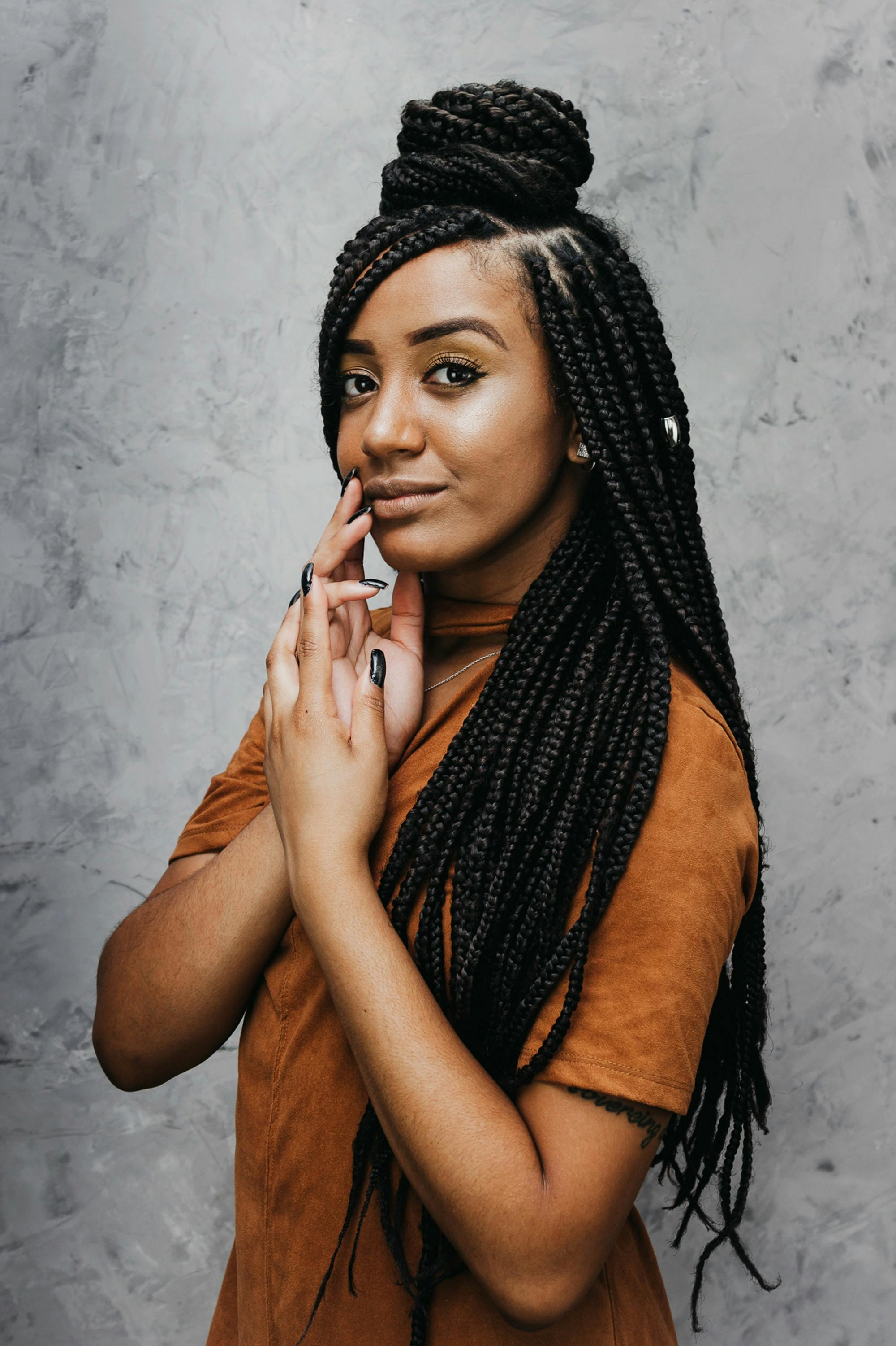 Woman With Long Dreadlocks Smiling And Touching Her Cheek
