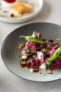 Elegant gourmet dish with grilled meats and greens in a high-end Tokyo restaurant.