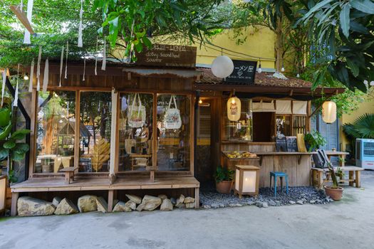 Charming rustic cafe surrounded by lush greenery offering a cozy vintage ambiance.