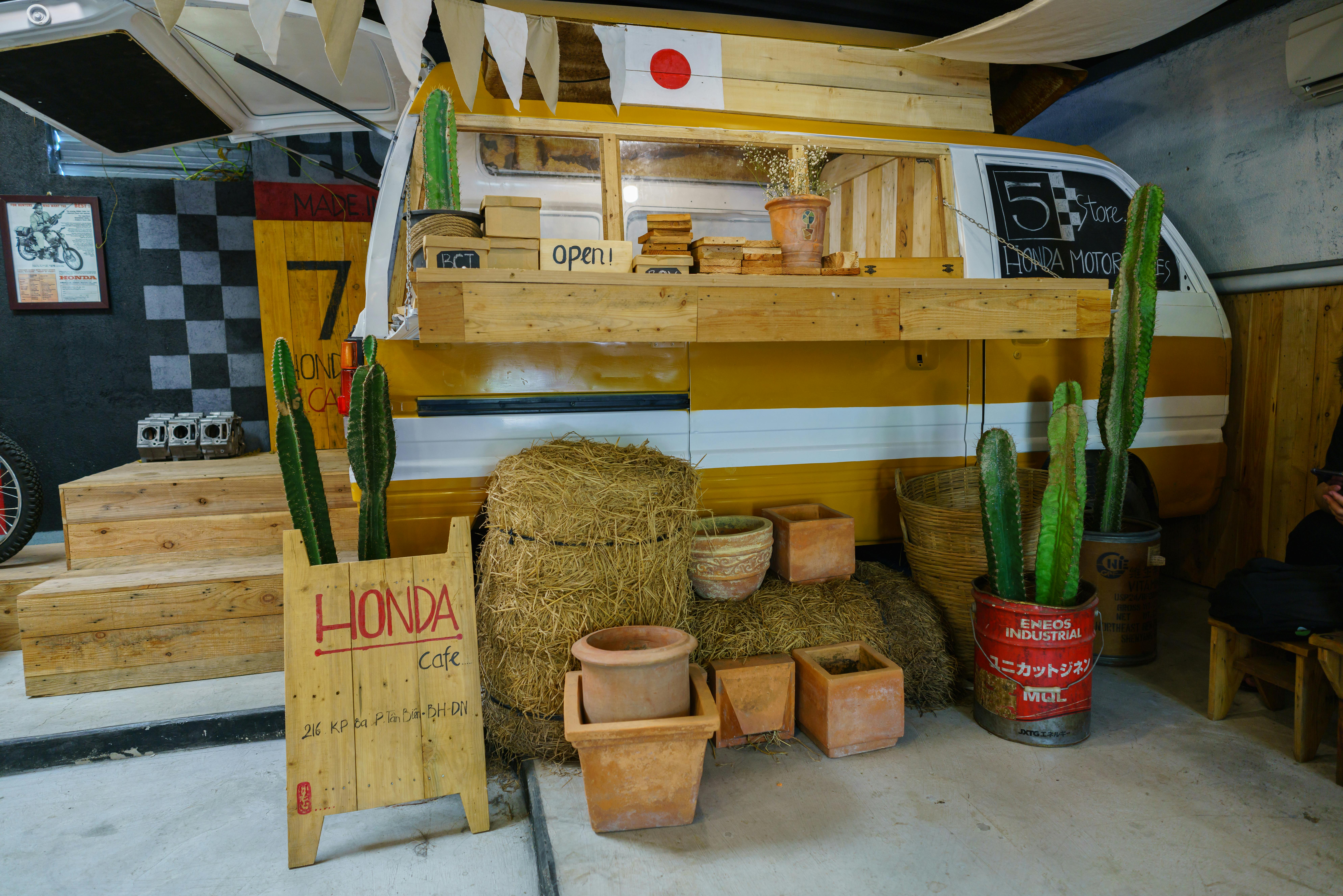 Rustic camper cafe setup with cacti and wooden decor in an indoor setting.