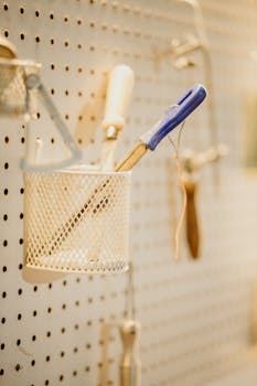 Close-up of workshop tools on a pegboard, showcasing organization and craftsmanship.
