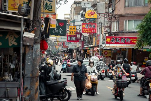 Free Bustling street scene with people and scooters in New Taipei City, Taiwan, capturing the lively local atmosphere. Stock Photo