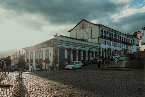 Free Sunlit historic town square with cobblestone streets and classic architecture. Stock Photo