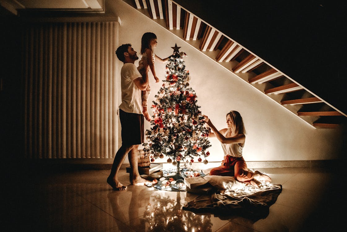 Free Family Decorating Their Christmas Tree Stock Photo
