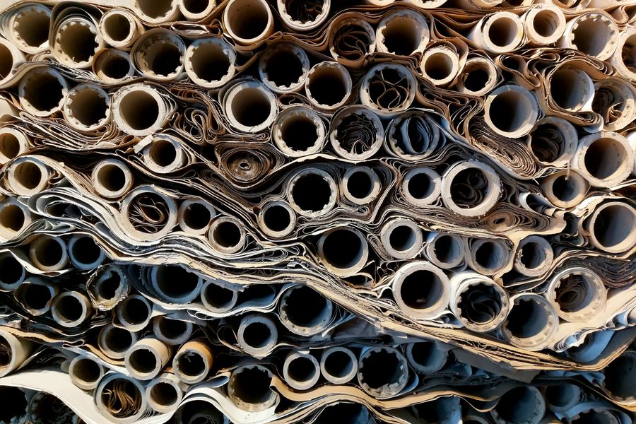 Close-up view of stacked rolled paper tubes, showcasing texture and patterns.