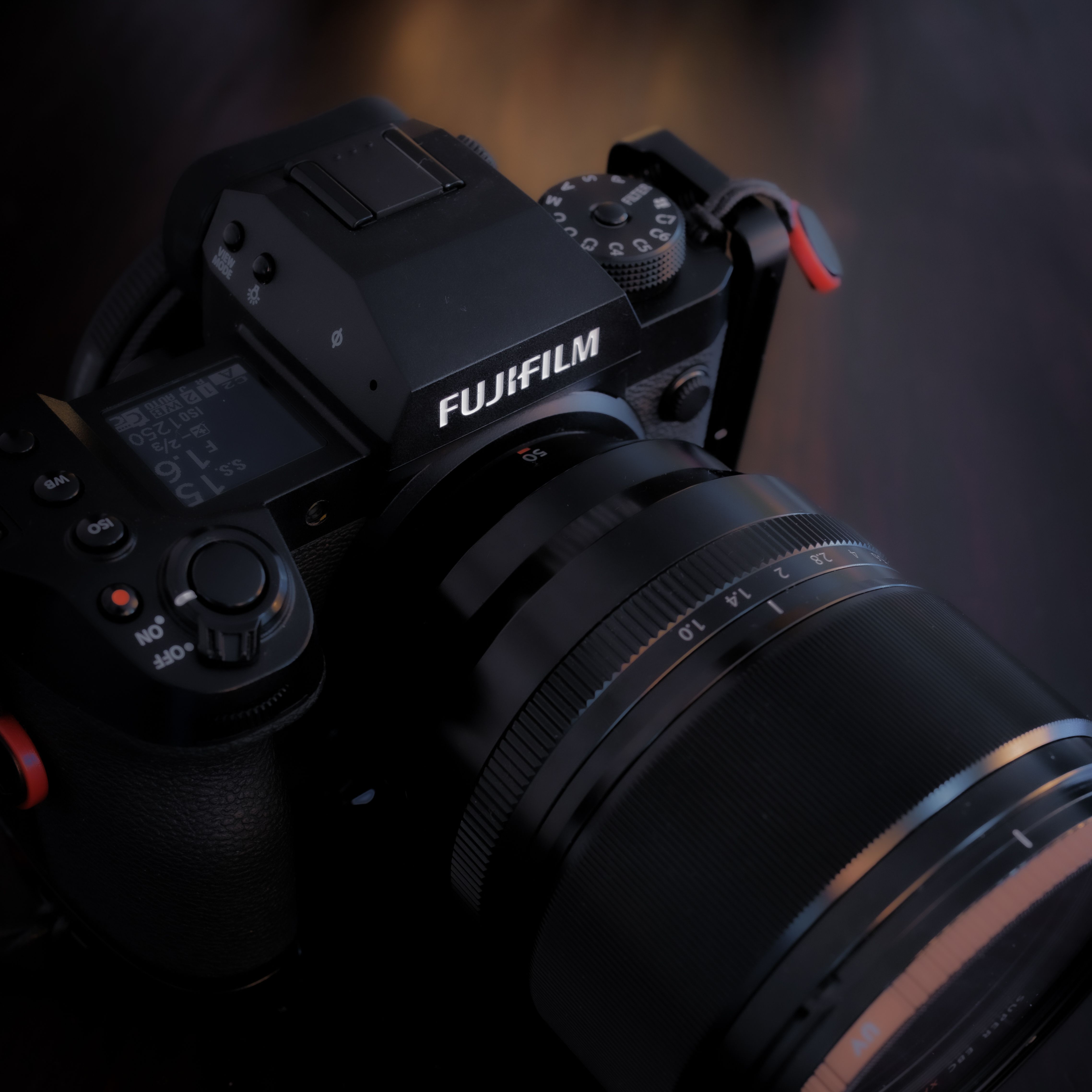 Detailed view of a Fujifilm camera showcasing the lens and control dials.