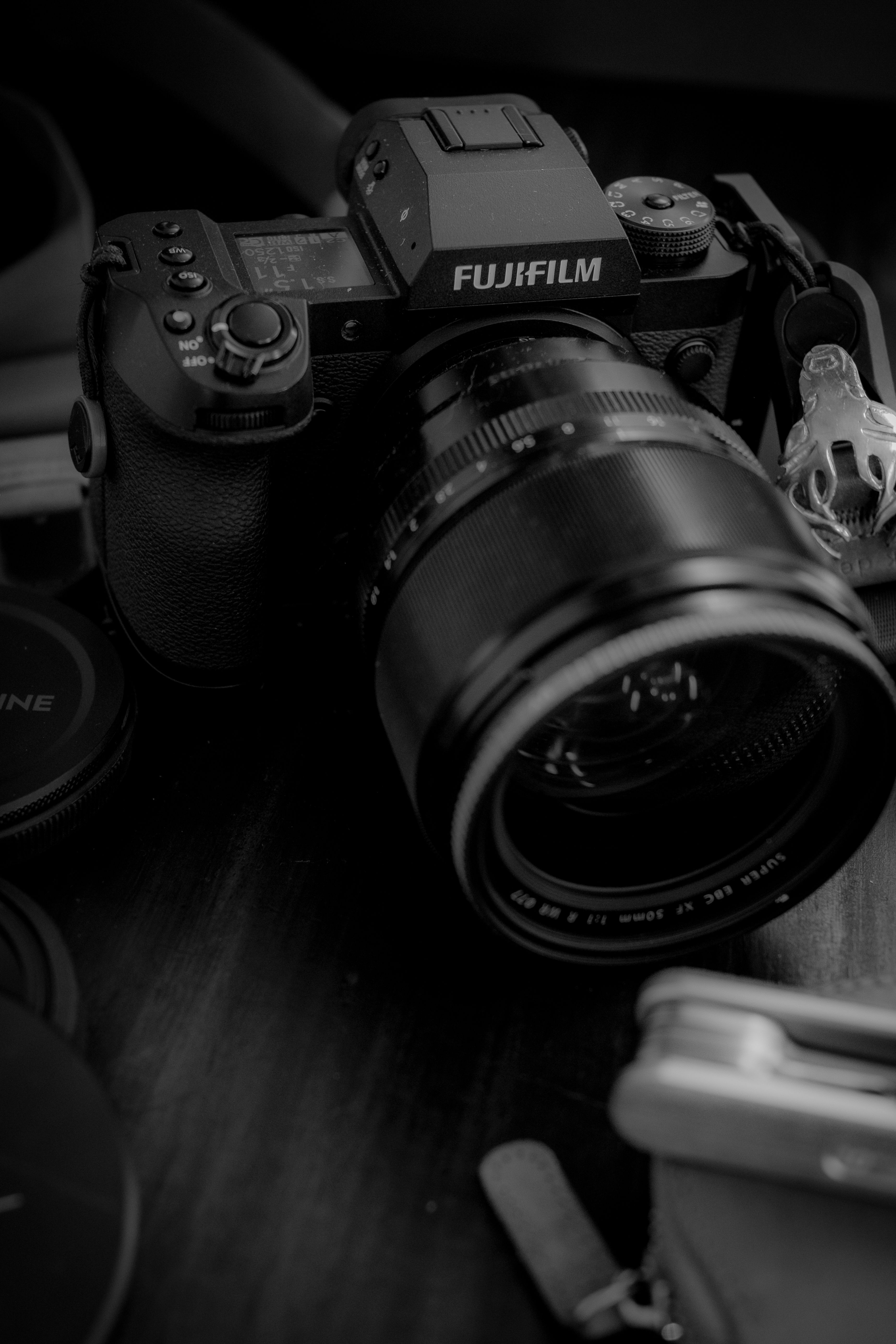 Close-up of a Fujifilm camera with lens, perfect for photography-related projects.