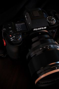 Detailed shot of a Fujifilm camera with a 50mm lens, showcasing its controls and design.