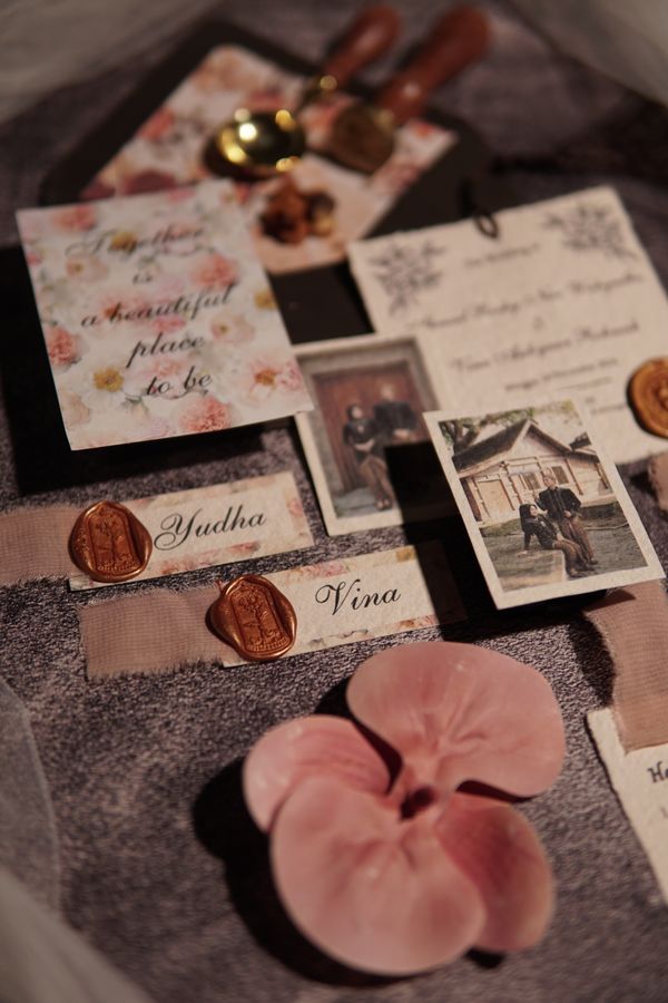 Wedding invitation suite with wax seals and floral details
