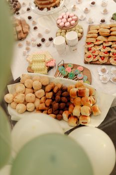 A festive dessert table with various pastries and sweets perfect for parties.