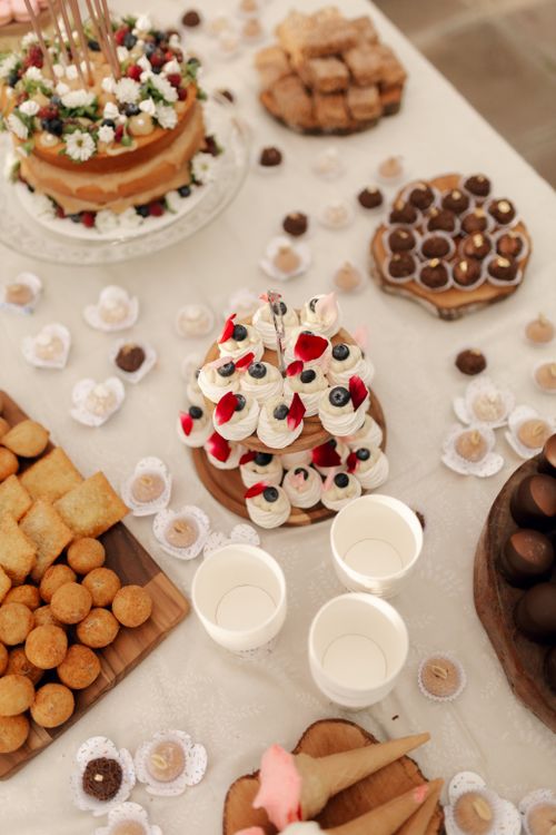 Free A beautifully arranged table showcasing a variety of elegant desserts including cakes, pastries, and chocolates. Stock Photo