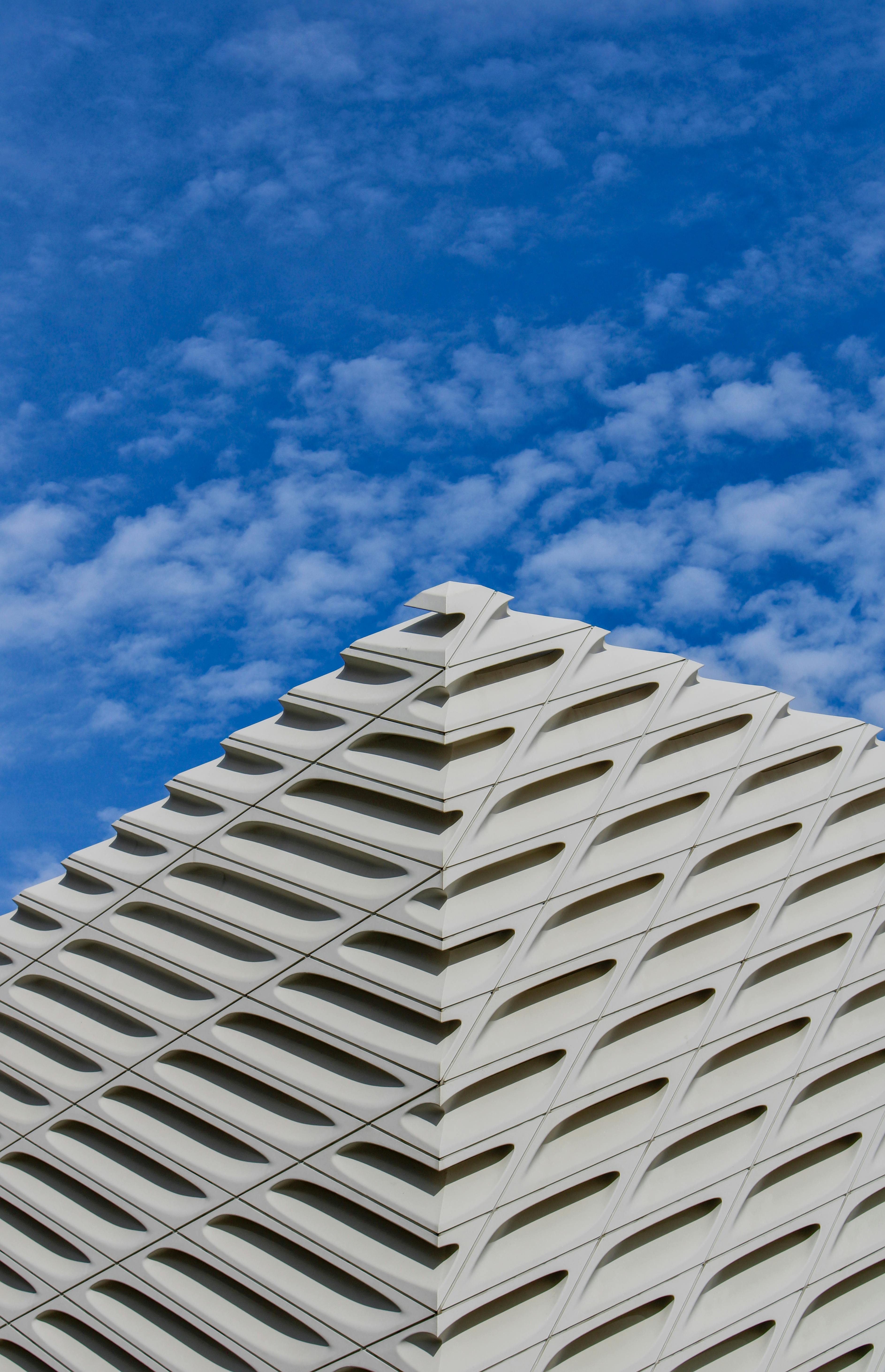 Modern architectural structure with unique design set against a bright blue sky.