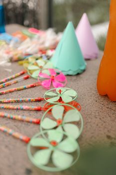 Vibrant close-up of party decorations featuring paper hats and colorful pinwheels.